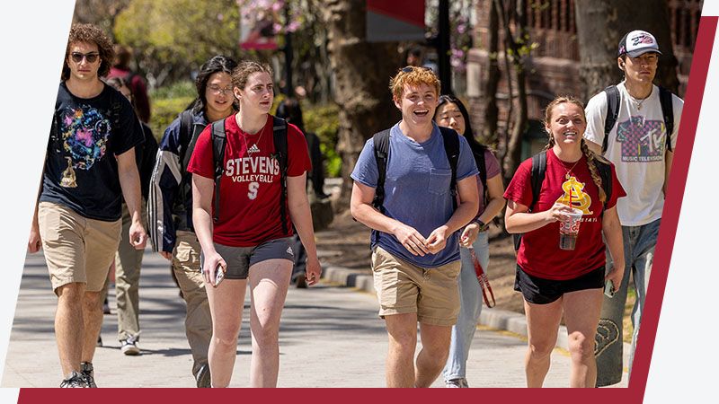 Students head to class up Wittpenn Walk on a sunny day.