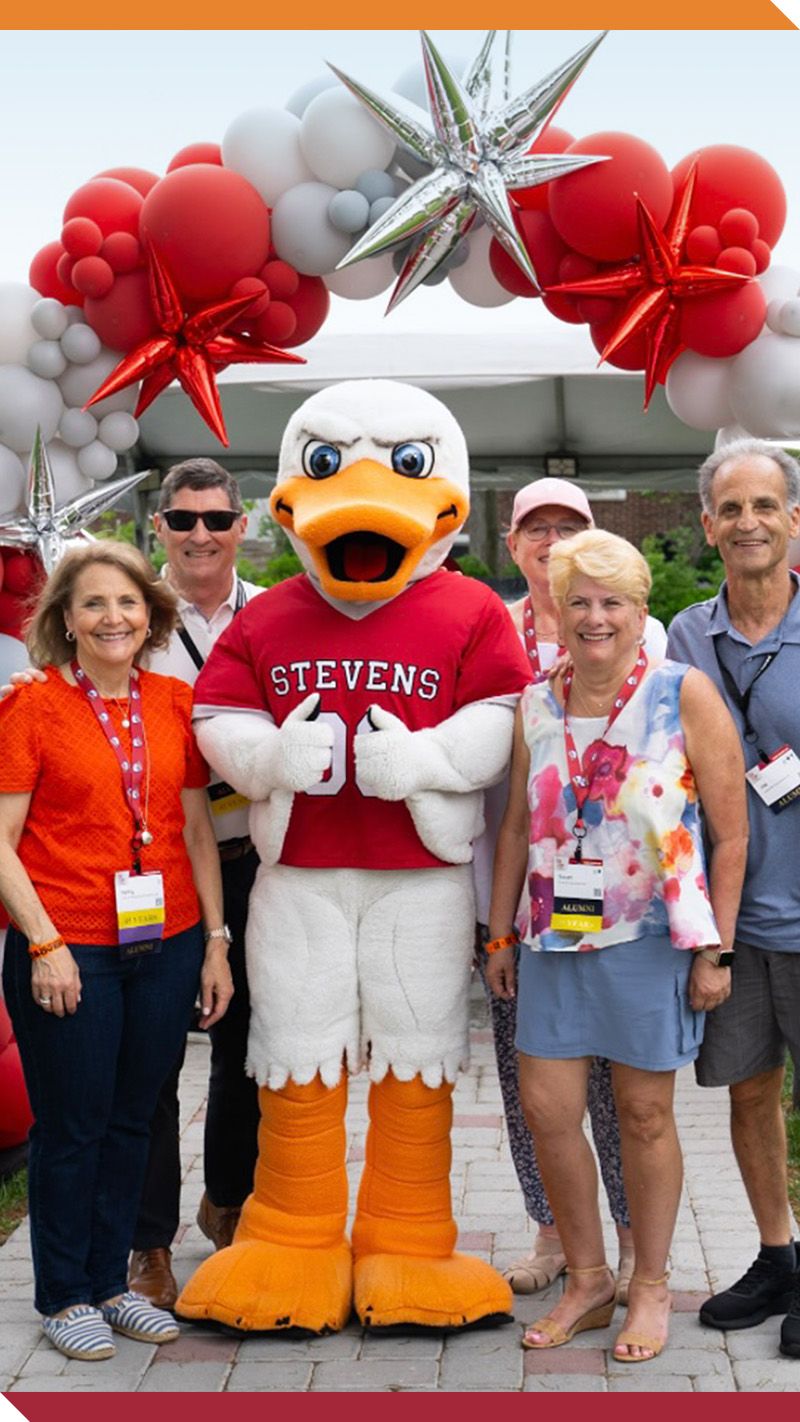 Atilla gives a thumbs up as he hangs out with a group of alumni.